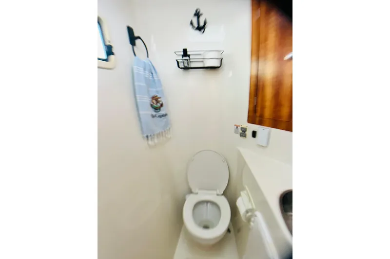 Slide: The Image of Compact bathroom in 2007 PDQ MV41 boat with toilet, towel, and anchor decor. - 45