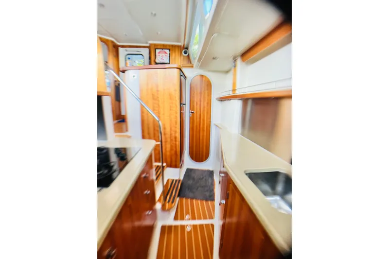 Slide: The Image of 2007 PDQ MV41 yacht interior with wood paneling and modern kitchen amenities. - 47