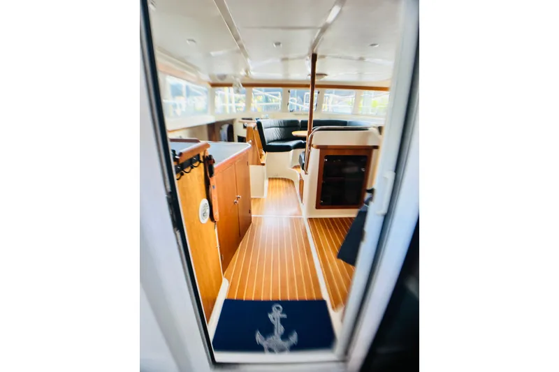 Slide: The Image of Interior of 2007 PDQ MV41 boat with wood flooring and seating area. - 5