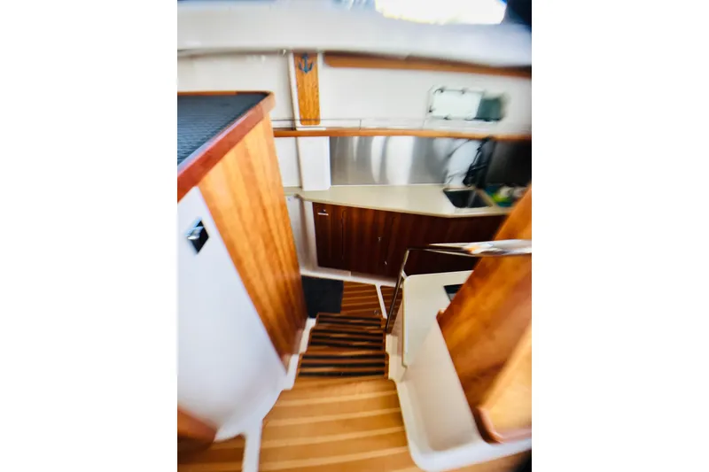 Slide: The Image of Interior of 2007 PDQ MV41 boat with wooden cabinetry and compact kitchen area. - 51
