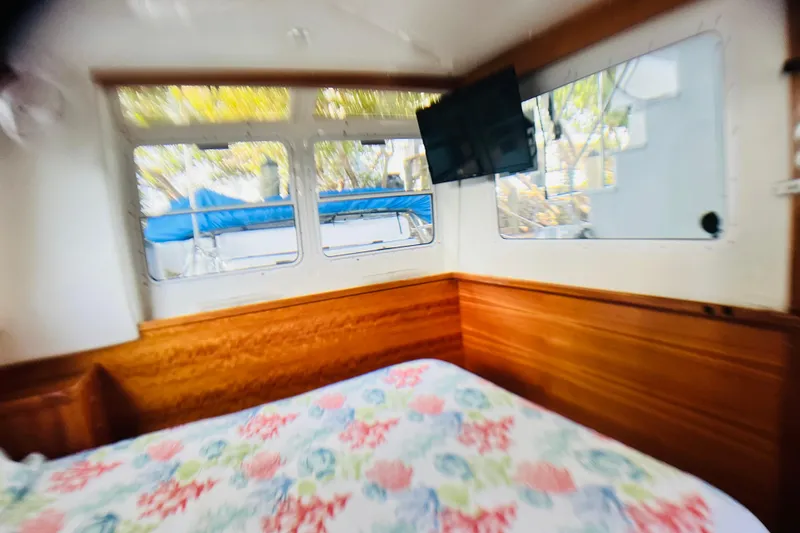 Slide: The Image of Cozy cabin interior of 2007 PDQ MV41 with floral bedding and mounted TV. - 52