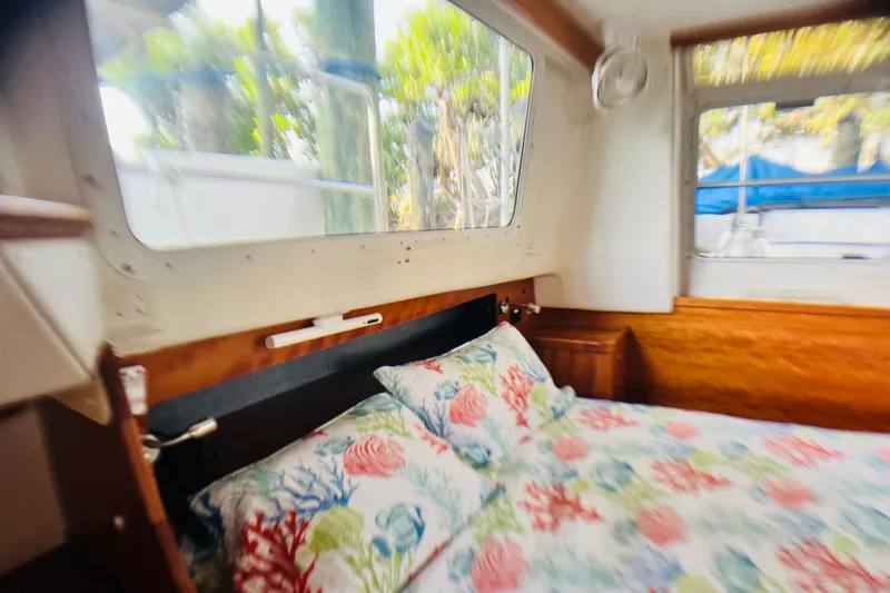 Slide: The Image of Cozy cabin interior of 2007 PDQ MV41 with floral bedding and large windows. - 53