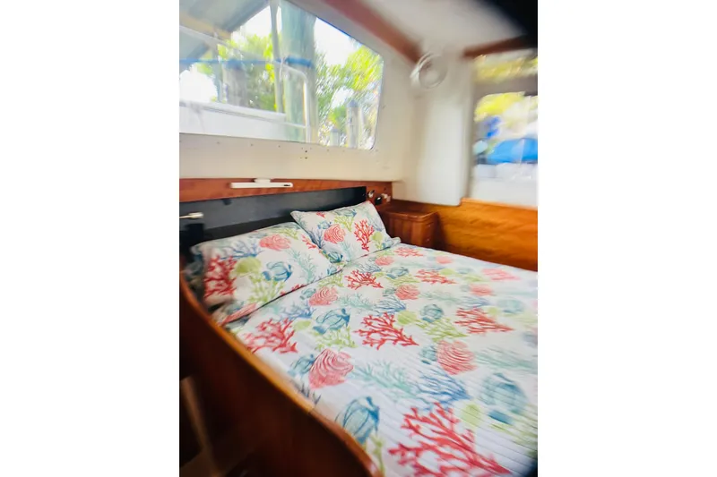 Slide: The Image of Cozy cabin interior of 2007 PDQ MV41 with colorful bedding and large windows. - 54