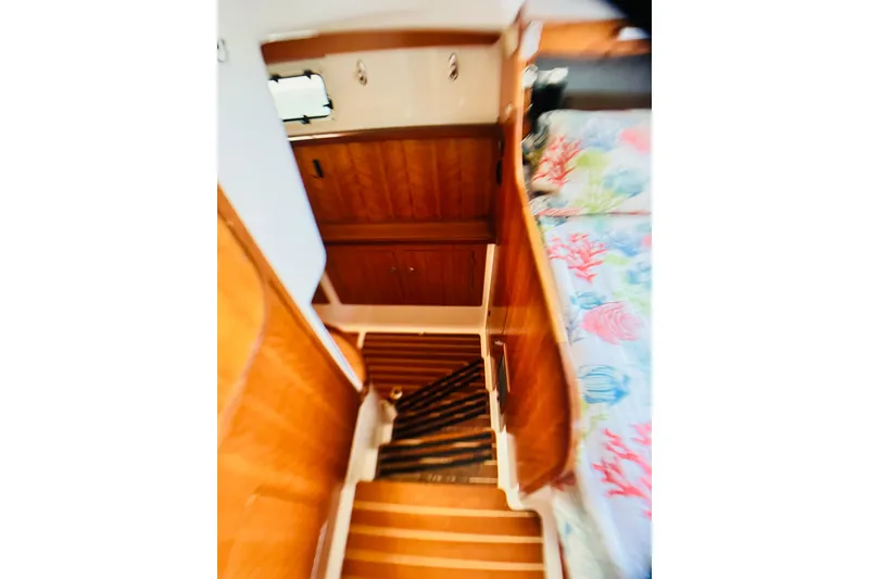 Slide: The Image of Interior of 2007 PDQ MV41 boat with wooden cabinetry and colorful bedding. - 55