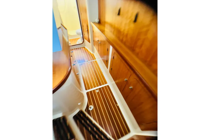 Slide: The Image of Interior of 2007 PDQ MV41 boat with wooden cabinetry and striped flooring. - 56