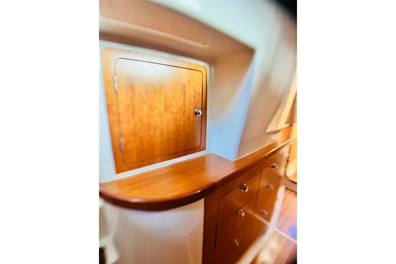 Slide: The Image of Wooden cabinetry inside a 2007 PDQ MV41 boat, featuring sleek design and storage. - 58