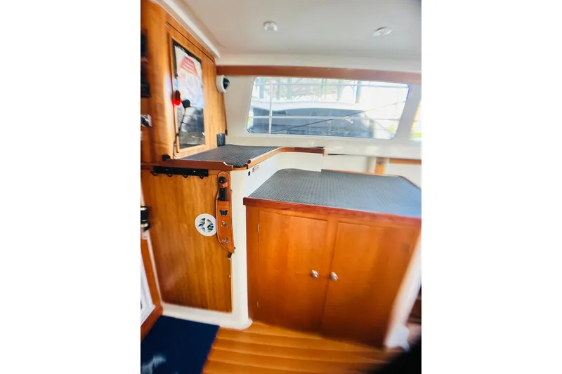 Slide: The Image of Interior of 2007 PDQ MV41 boat with wooden cabinetry and large window. - 6