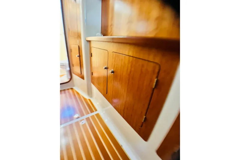 Slide: The Image of Wooden cabinetry inside a 2007 PDQ MV41 boat, featuring sleek design and polished finish. - 60