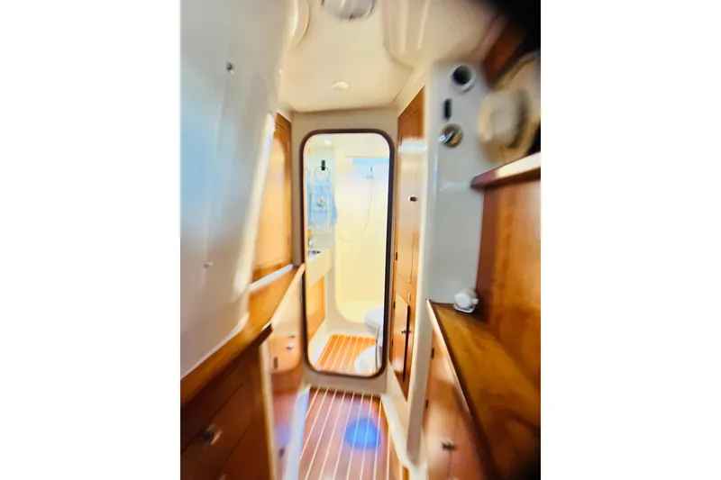Slide: The Image of Interior of 2007 PDQ MV41 boat, featuring wooden cabinetry and a compact bathroom. - 61
