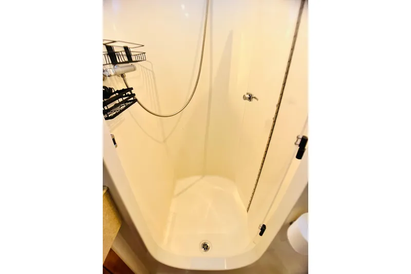 Slide: The Image of Compact shower area in a 2007 PDQ MV41 boat, featuring a sleek design. - 66