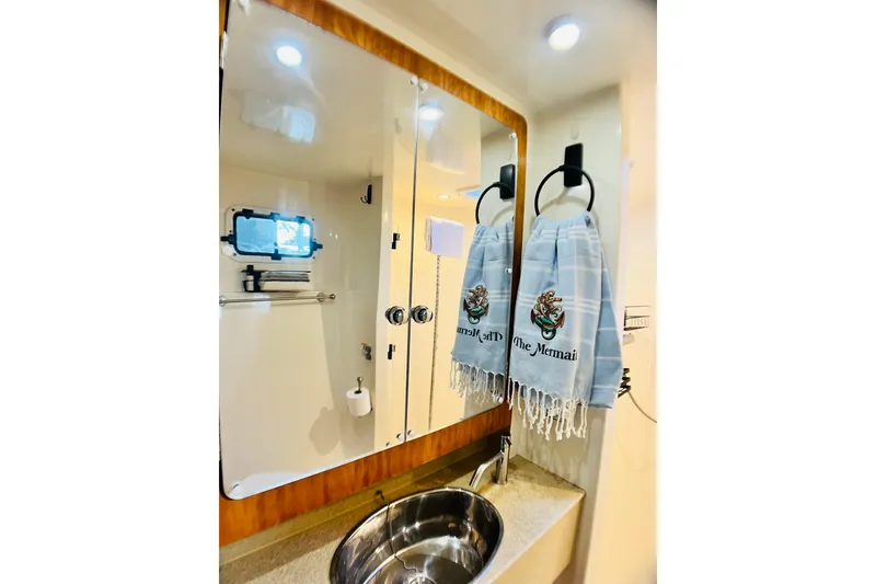 Slide: The Image of Bathroom interior of 2007 PDQ MV41 yacht with mirror, sink, and decorative towel. - 67