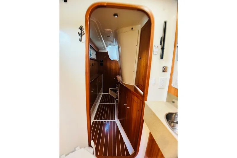 Slide: The Image of Interior of 2007 PDQ MV41 boat, featuring wood paneling and compact design. - 70