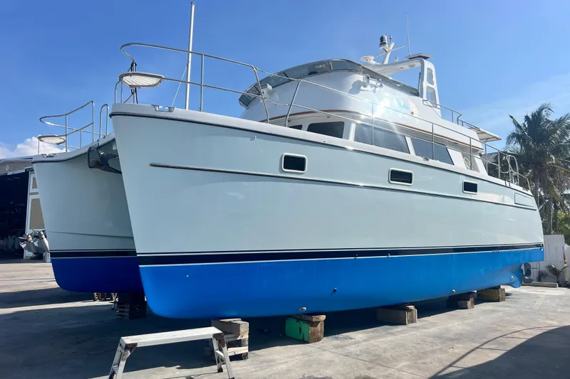 Slide: The Image of 2007 PDQ MV41 catamaran on dry dock, blue hull, sunny day. - 73