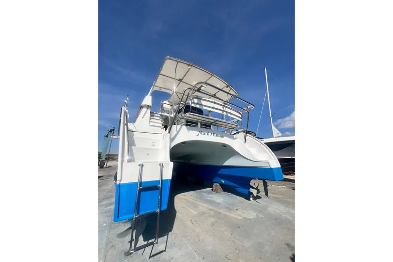 Slide: The Image of 2007 PDQ MV41 boat on dry dock, Maui, Hawaii, under clear blue sky. - 77