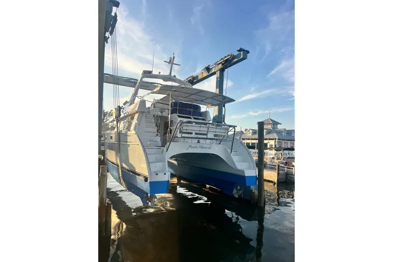 Slide: The Image of PDQ MV41 2007 catamaran in dry dock, marina background, clear sky. - 81