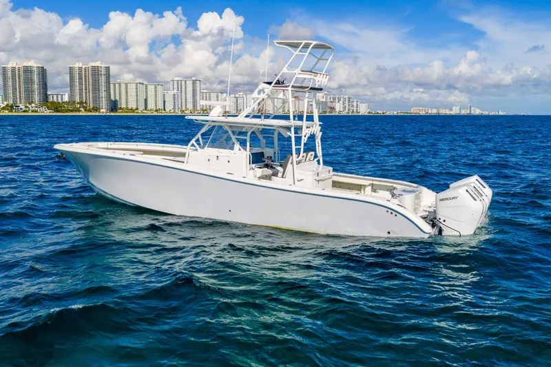 The Image of 2015 Yellowfin 42 Offshore boat on blue ocean with city skyline background. - 0