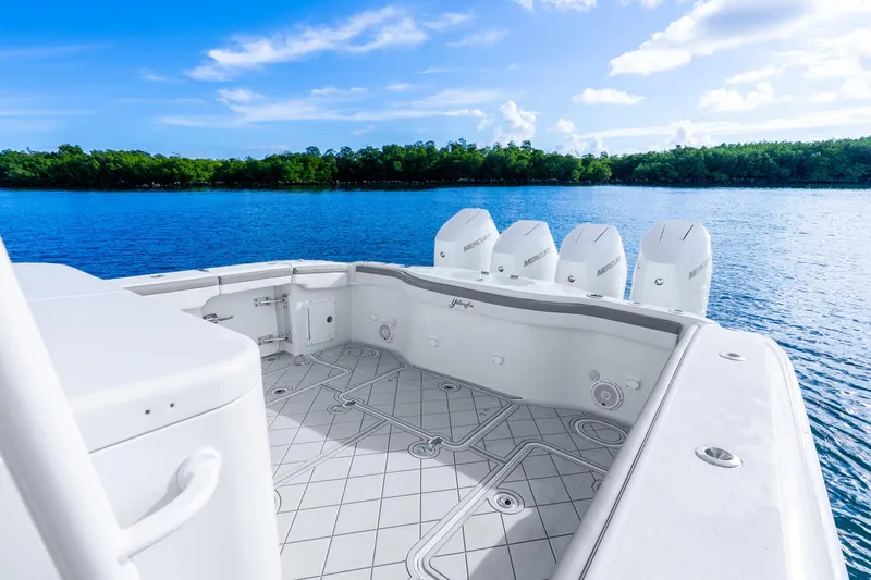 Slide: The Image of 2015 Yellowfin 42 Offshore boat with multiple engines on a serene blue lake. - 19