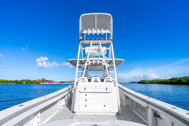 Slide: The Image of 2015 Yellowfin 42 Offshore boat on calm water under clear blue sky. - 23