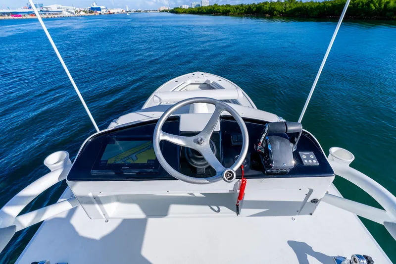 Slide: The Image of Helm view of 2015 Yellowfin 42 Offshore boat on calm water. - 28