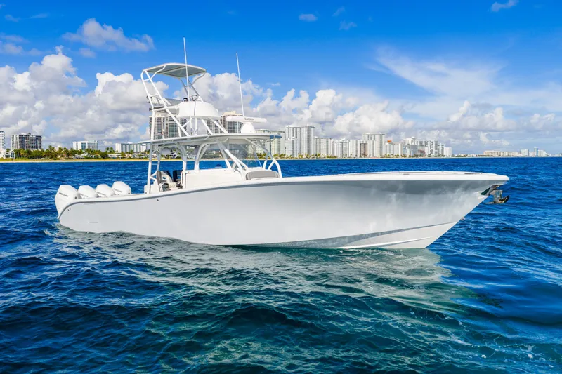 Slide: The Image of 2015 Yellowfin 42 Offshore boat cruising on blue ocean near city skyline. - 3