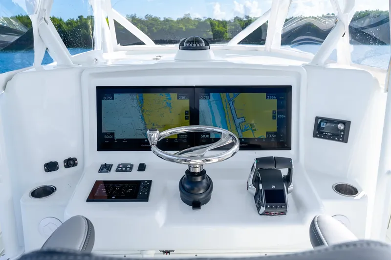 Slide: The Image of Cockpit of 2015 Yellowfin 42 Offshore boat with navigation screens and controls. - 31