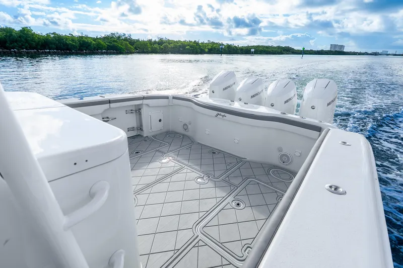 Slide: The Image of 2015 Yellowfin 42 Offshore boat with multiple outboard engines cruising on a sunny day. - 34