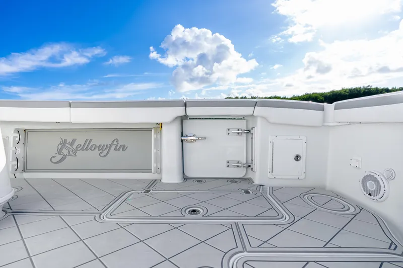 Slide: The Image of 2015 Yellowfin 42 Offshore boat deck with logo, under a bright blue sky. - 35