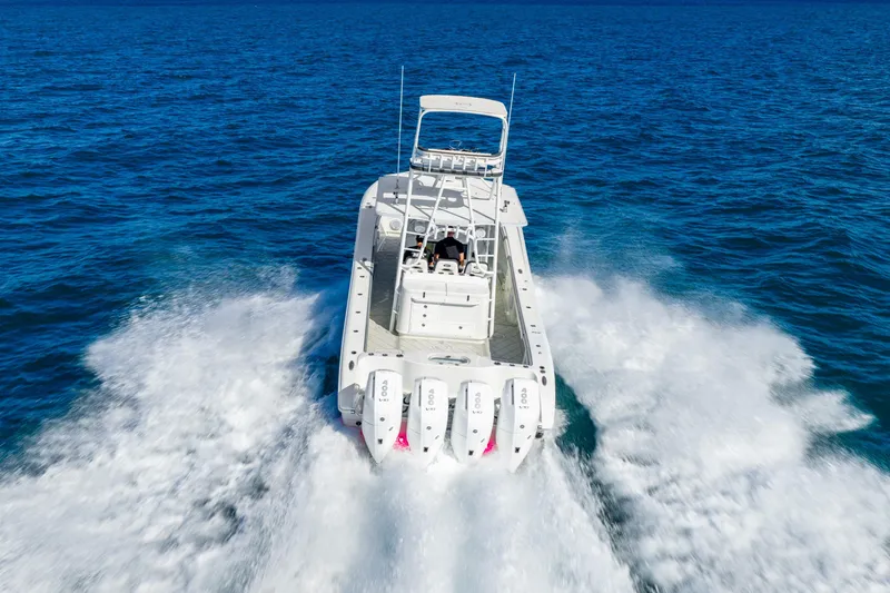 Slide: The Image of 2015 Yellowfin 42 Offshore boat speeding on open ocean waters. - 9