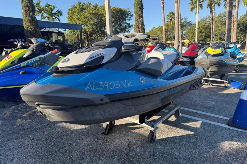 Slide: The Image of 2021 Sea-Doo GTI SE 130 jet ski in a parking lot with palm trees. - 4
