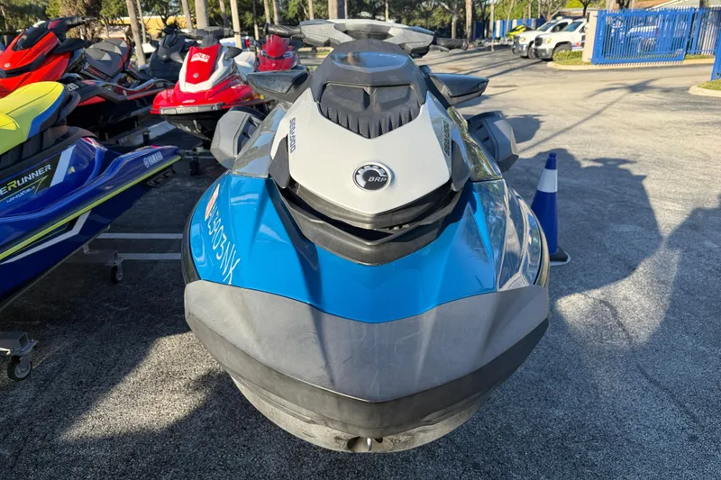 Slide: The Image of 2021 Sea-Doo GTI SE 130 jet ski, blue and gray, parked outdoors. - 5