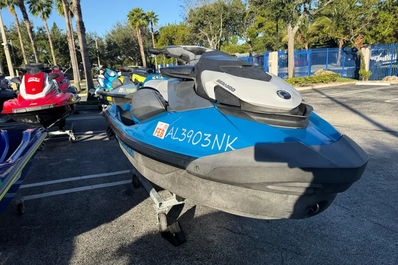 Slide: The Image of 2021 Sea-Doo GTI SE 130 jet ski in parking lot, blue and gray design. - 6