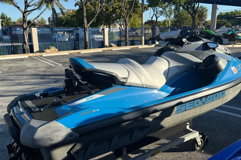 Slide: The Image of 2021 Sea-Doo GTI SE 130 jet ski in a parking lot, blue and gray design. - 7