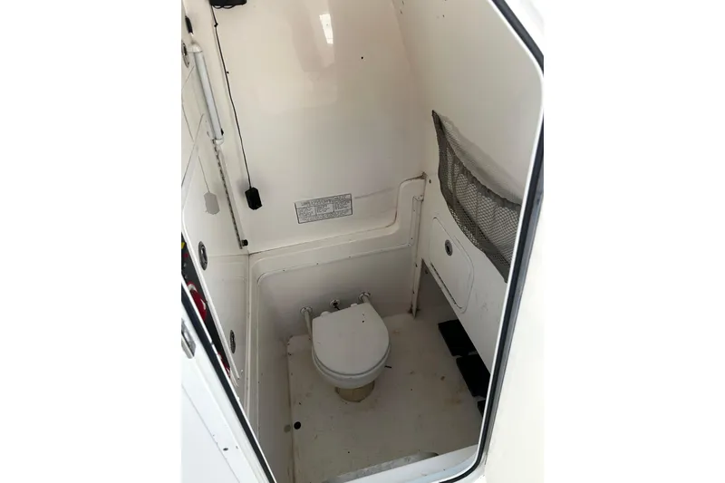 Slide: The Image of 2008 Regulator 26 Forward Seating boat interior with compact marine toilet. - 10