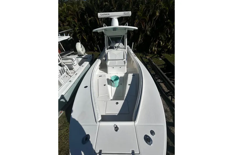 Slide: The Image of 2008 Regulator 26 Forward Seating boat with Garmin equipment, docked outdoors. - 6