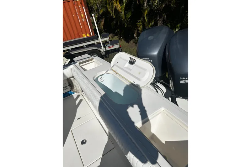Slide: The Image of 2008 Regulator 26 Forward Seating boat with open storage compartments and dual Yamaha engines. - 9