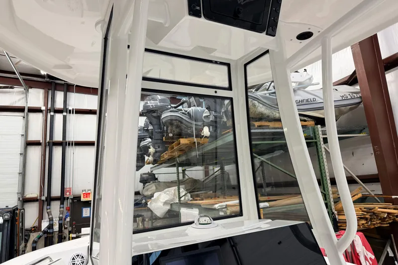 Slide: The Image of 2026 Tidewater 210 CC Adventure boat console with steering wheel and controls. - 10