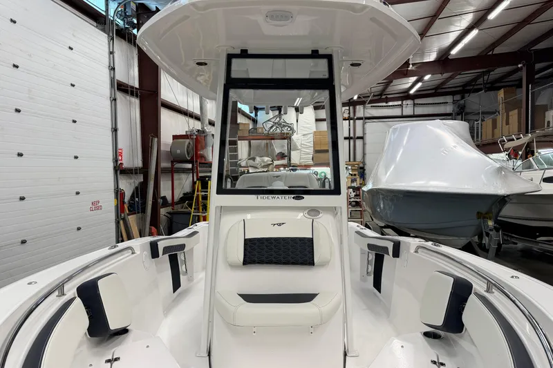 Slide: The Image of 2026 Tidewater 210 CC Adventure boat seat with Yamaha engine in a showroom. - 12