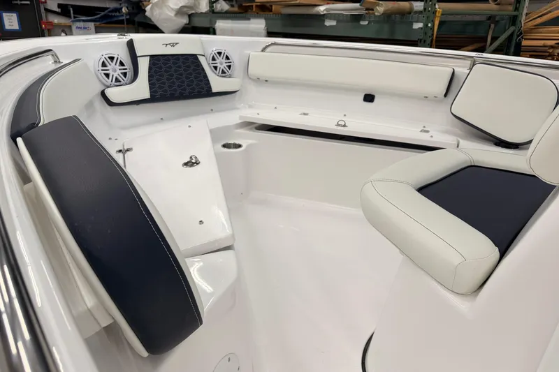 Slide: The Image of 2026 Tidewater 210 CC Adventure boat in a storage facility, showcasing interior seating and design. - 13