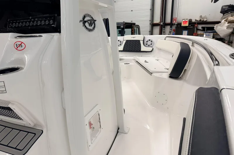 Slide: The Image of 2026 Tidewater 210 CC Adventure boat interior with cushioned seating and speakers. - 14