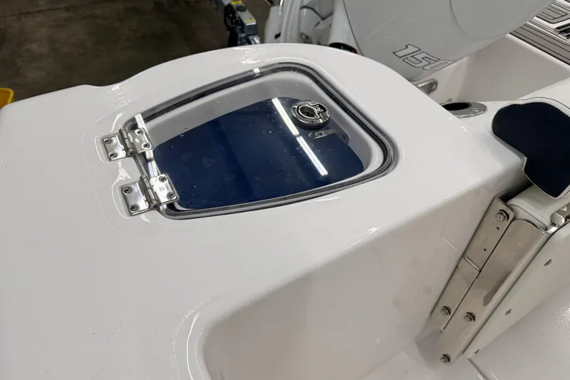 Slide: The Image of 2026 Tidewater 210 CC Adventure boat interior with logo and seating detail. - 17