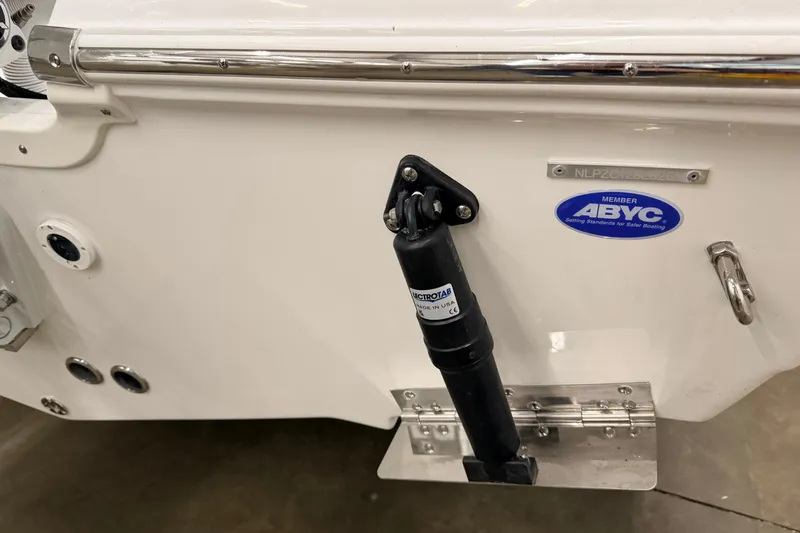 Slide: The Image of 2026 Tidewater 210 CC Adventure boat, close-up of logo on white hull. - 21