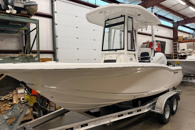 Slide: The Image of 2026 Tidewater 210 CC Adventure boat on trailer in a garage setting. - 3