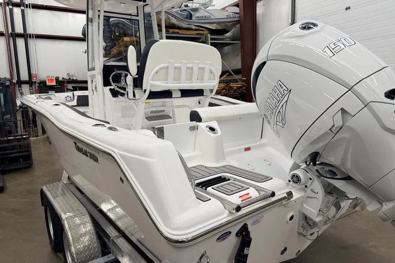 Slide: The Image of 2026 Tidewater 210 CC Adventure boat on trailer in warehouse setting. - 4