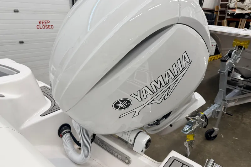Slide: The Image of 2026 Tidewater 210 CC Adventure boat with Yamaha 150 engine in a showroom. - 5