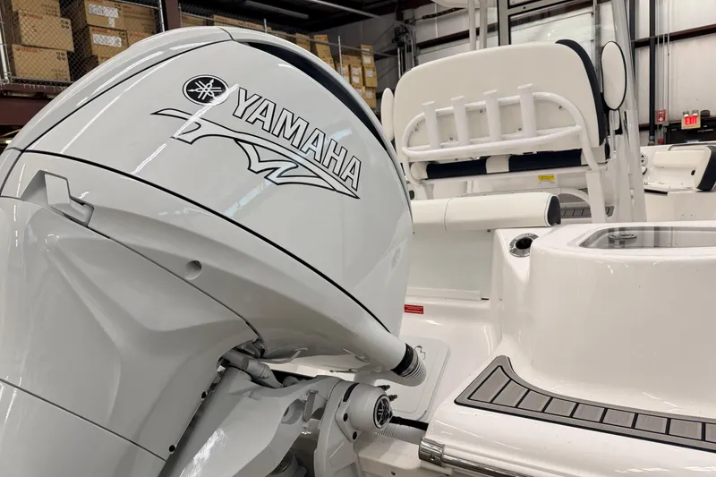 Slide: The Image of 2026 Tidewater 210 CC Adventure with Yamaha outboard motor in a showroom. - 6