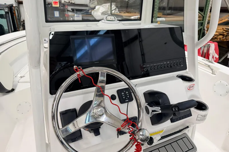 Slide: The Image of 2026 Tidewater 210 CC Adventure boat interior in a workshop setting. - 8