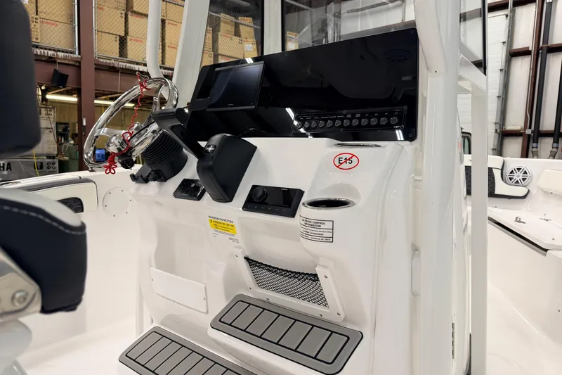 Slide: The Image of 2026 Tidewater 210 CC Adventure boat dashboard with steering wheel and control panel. - 9