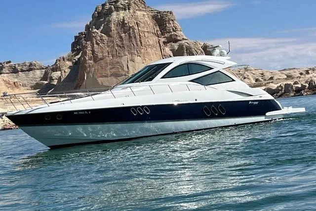 The Image of 2009 CRUISERS YACHT 520SC on water, rocky cliffs in background. - 0