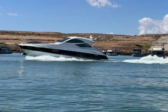 Slide: The Image of 2009 CRUISERS YACHT 520SC sailing on a calm lake under a clear blue sky. - 1