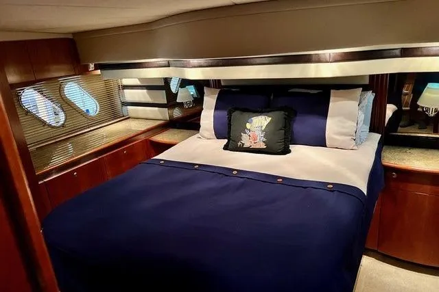 Slide: The Image of Luxurious bedroom interior of 2009 CRUISERS YACHT 520SC with elegant bedding and wood accents. - 10